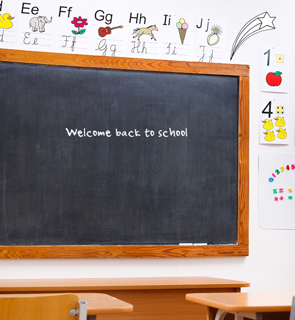 Empty classroom and black chalkboard, decorated with letters and numbers